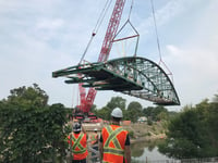 The frame of Blackfriars Bridge being lifted back into place across the Thames River.