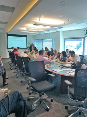 People eating lunch while listening to speaker